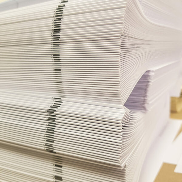 A stack of blank paper, book blocks prepared for binding in a printing house.